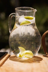 Pitcher of Cold Water With Fresh Lime Slices Outdoors
