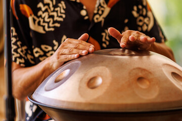 Hands Playing Handpan Drum in Warm Natural Light