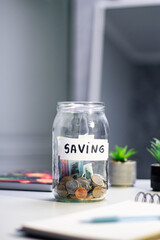 Future planning with long term savings jar. Hand adding substantial savings to future security container. Financial planning and safety concepts