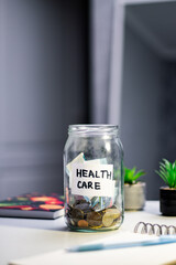 Health goal savings in labeled jar. Person contributing to Healthcare fund jar, representing wellness investment and proactive approach to medical expenses