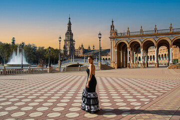 the Andalusian girl with a flamenco dress in one of the most beautiful squares of Seville in Andalusia