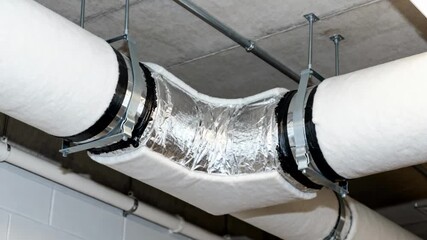 Medium shot showing mixedair ductwork upgrade highlighting careful sealing and insulation of junctions to optimize temperature control.
