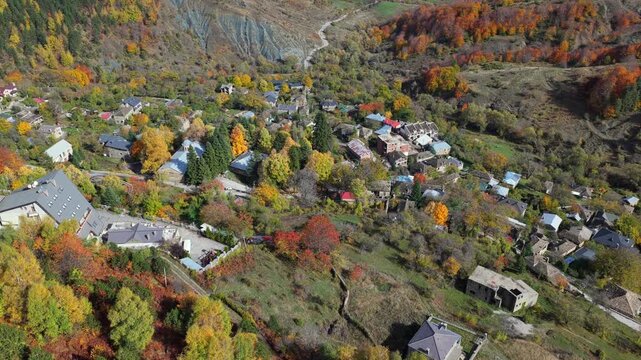 Autumn aerial video of Dardh&euml; showing colourful forests, mountain slopes and the village nestled beautifully among vibrant seasonal foliage.