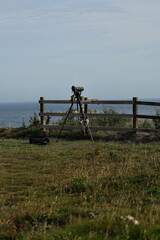 Naklejka premium A lonely telescope on a tripod,looking beyond the horizon