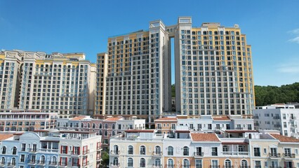 Phu Quoc, Sunset Town, Vietnam. 4k high-quality footage taken with a Drone showcasing colorful buildings, blue skies, a watch tower, a kissing bridge, turquoise clear waters, green forest, golden sand