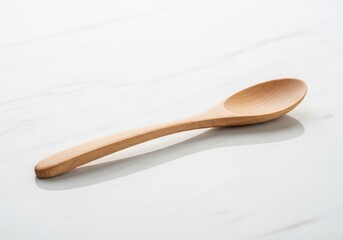 Natural wood serving utensil rests upon a bright, polished surface