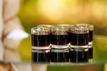 Row of Dark Shots in Clear Glasses