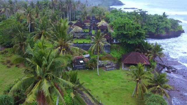 The Hindu temple of Pura Dalem from a bird's-eye view. The temple is located on Pantai Bonian Beach, which has volcanic black sand, in the Indian Ocean on the island of Bali. Dron. 4К