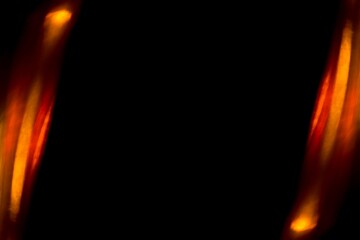 Twin golden light overlays rise like molten pillars on either side of a dark void, framing the center with warm radiant fire and suggesting a glowing gateway suspended in infinite black space

