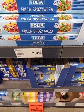 Folia food wrap packaging with fresh fruit and salad images on a store shelf
