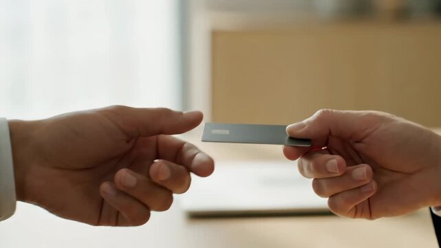 Businessman in a Suit Giving a USB Flash Drive to a Partner.