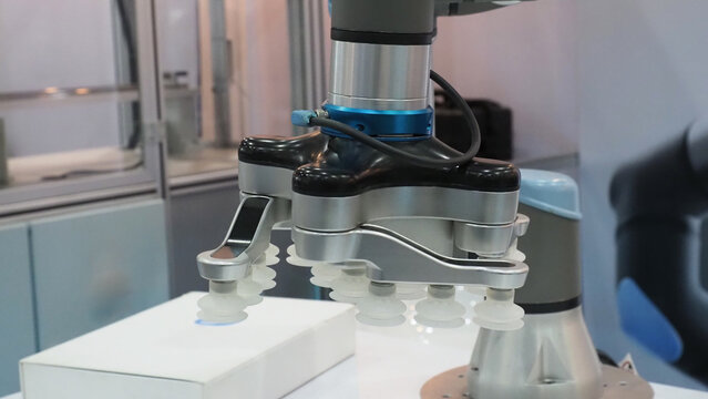 An industrial robotic arm equipped with a vacuum suction gripper.