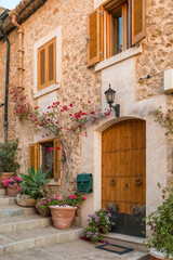 Picturesque street with stone buildings and flowers in Pollensa