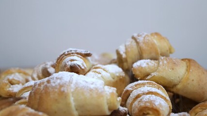 Freshly baked homemade croissants sprinkled with powdered sugar