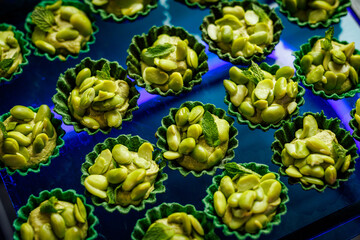 Green bean tartlets on blue tray