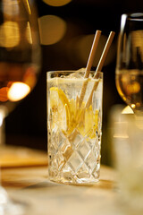 Citrus drink in crystal glass on table