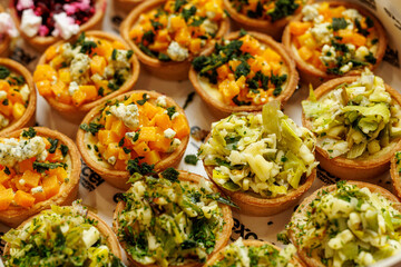Colorful vegetable tartlets assortment top view