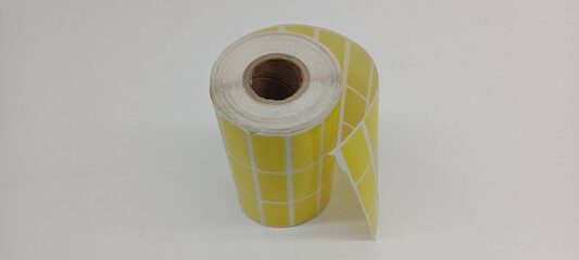 Yellow barcode sticker roll isolated on white background.