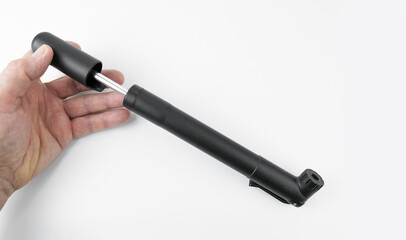 Small mini bicycle pump on a white