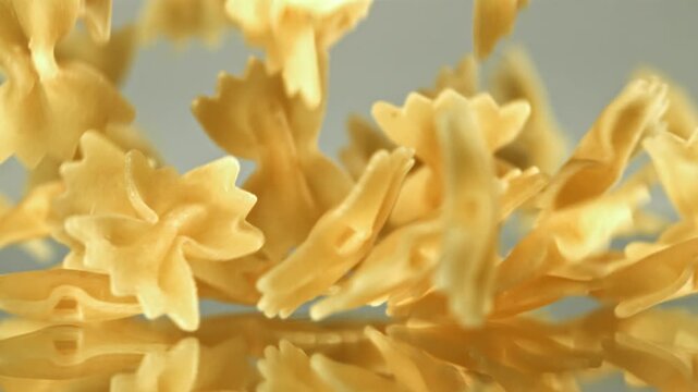 Super slow motion dry farfalle pasta . Filmed on a high-speed camera at 1000 fps. High quality FullHD footage
