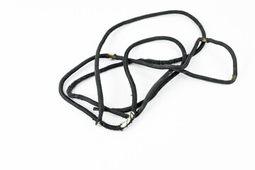 Worn out black shoe lace on a white