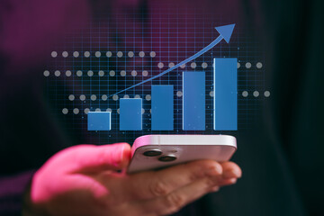 Trends in data growth shown on mobile phone screen with increasing graph