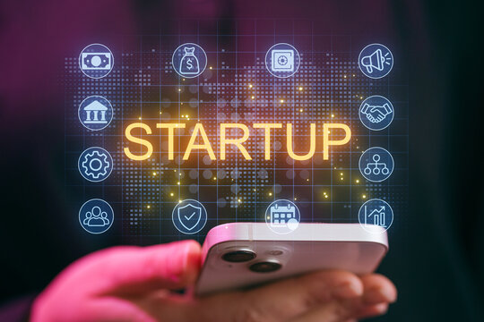 Visual representation of startup concepts with smartphone in hands and various business icons at night - Powered by Adobe