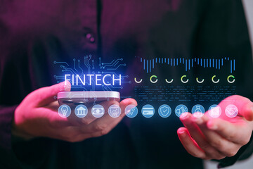 Fintech trends involving technology and mobile devices are presented during a business meeting in an office space in the afternoon