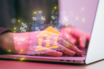 Person uses laptop to access online banking with interest rate graphics displayed on screen