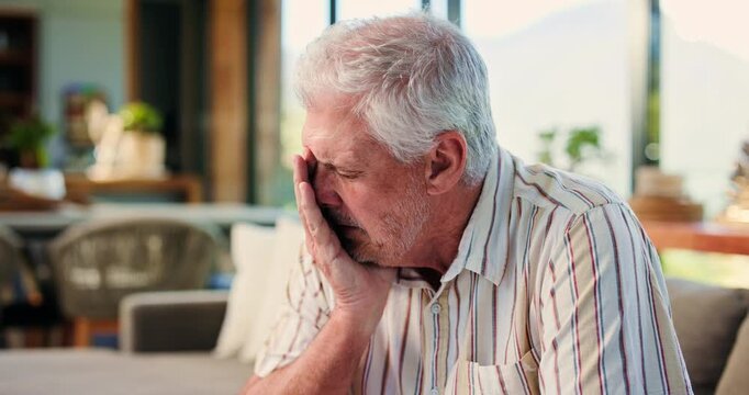 Elderly, sad man and crying with regret for past mistake, loss or grief on living room sofa in home. Senior, male person or emotional with old memory, nostalgia or mourning lost love for loneliness
