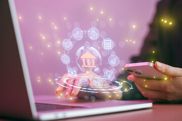 Working with digital banking tools on a laptop while using a smartphone