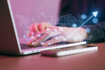 Person typing on laptop with data and graphs in view showing growth in a modern workspace during daytime