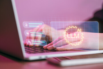 Typing on laptop with technology graphics displayed on screen in a workspace during daytime