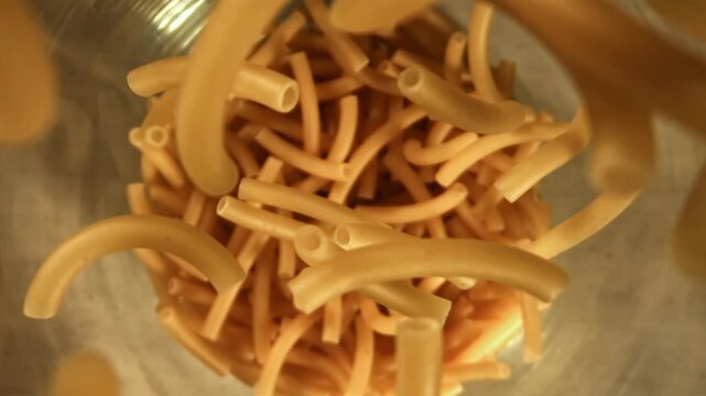 Super slow motion dry maccheroni pasta . Filmed on a high-speed camera at 1000 fps. High quality FullHD footage