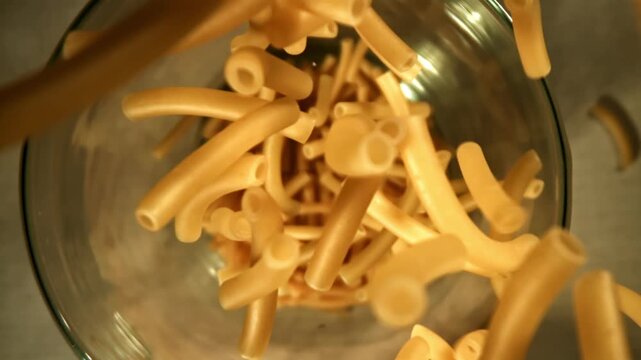 Super slow motion dry maccheroni pasta . Filmed on a high-speed camera at 1000 fps. High quality FullHD footage
