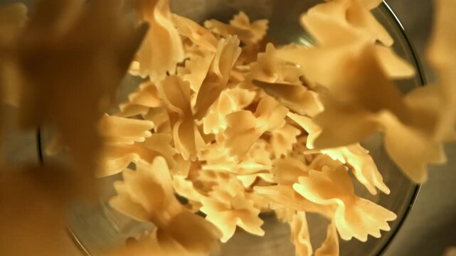 Super slow motion dry farfalle pasta . Filmed on a high-speed camera at 1000 fps. High quality FullHD footage