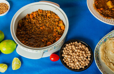 Traditional Moroccan Harira lentil soup pot, with a slice of lemon