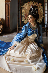 Rococo Antoinette queen sitting at fireplace