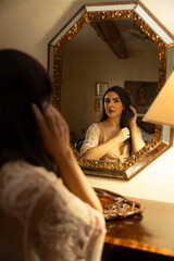 Beautiful young woman in nightgown reflected