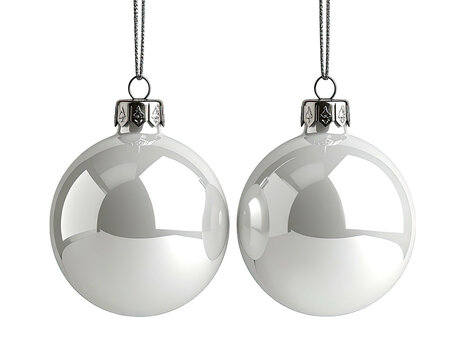 Two reflective, silver Christmas ornaments hanging against a black background