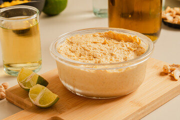 Delicious homemade hummus pasta with olive oil and chick-peas. Wooden table. Healthy food.