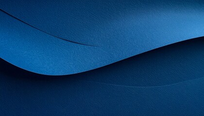 Overlapping sheets of textured blue paper arranged at angles, creating geometric shadows and rich tonal contrast.