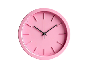 A pastel pink wall clock against a stark black background
