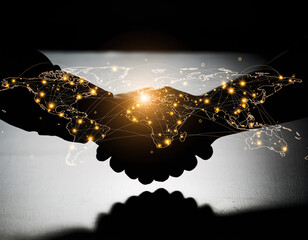 Hands join together while a world map shines above in a double exposure visual with lights connecting different places