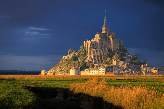 abbey of mont saint michel during sunset in the last light