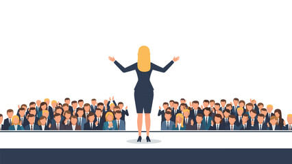 A confident blonde woman stands on a stage with her arms outstretched, addressing a large, attentive audience of diverse professionals.