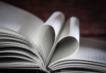 Open note book with two heart shaped pages isolated with copy space