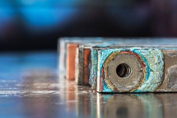 Patinated copper busbars showing the structure of oxidation, aging, and electrochemical corrosion on the metal surface in the power industry.