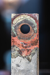 Patinated copper busbar showing the structure of oxidation, aging, and electrochemical corrosion on the metal surface in the power industry.