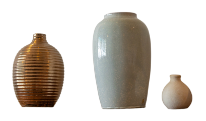 Three ceramic vases of different sizes and textures stand against a white background, showcasing earthy glazes, minimalist forms, and a quiet, modern still life composition.
